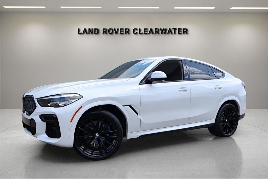 2023 BMW X6 M50i in Mineral White Metallic — front three-quarter view
